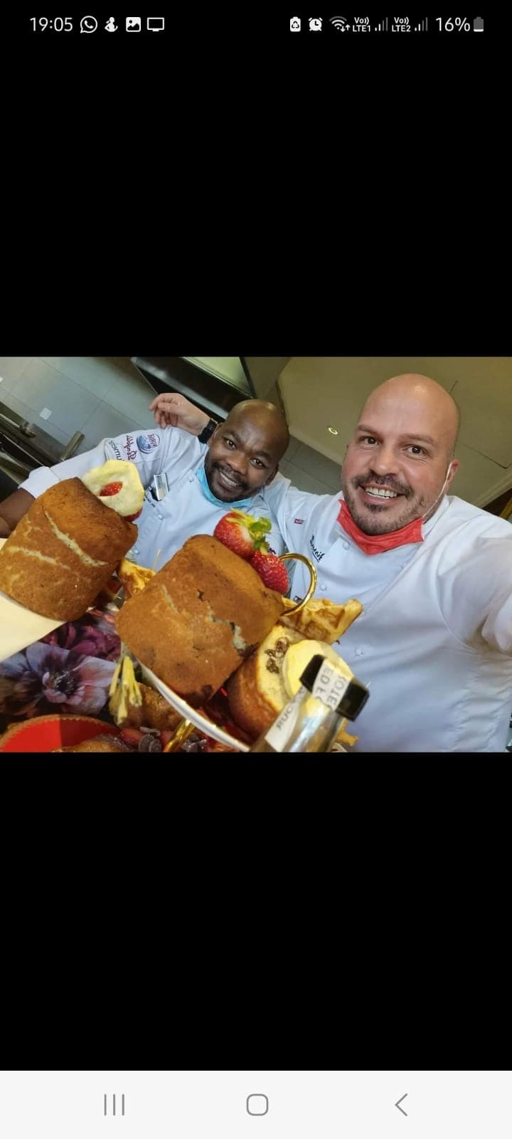 Chef Tristan sharing a moment with a fellow chef in the kitchen.